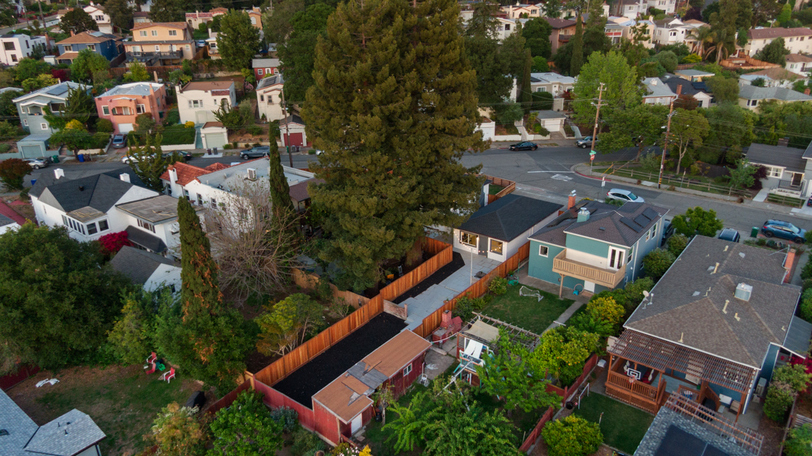 Aerial view highlighting the expansive lot, mature redwood trees, and private backyard setting.
